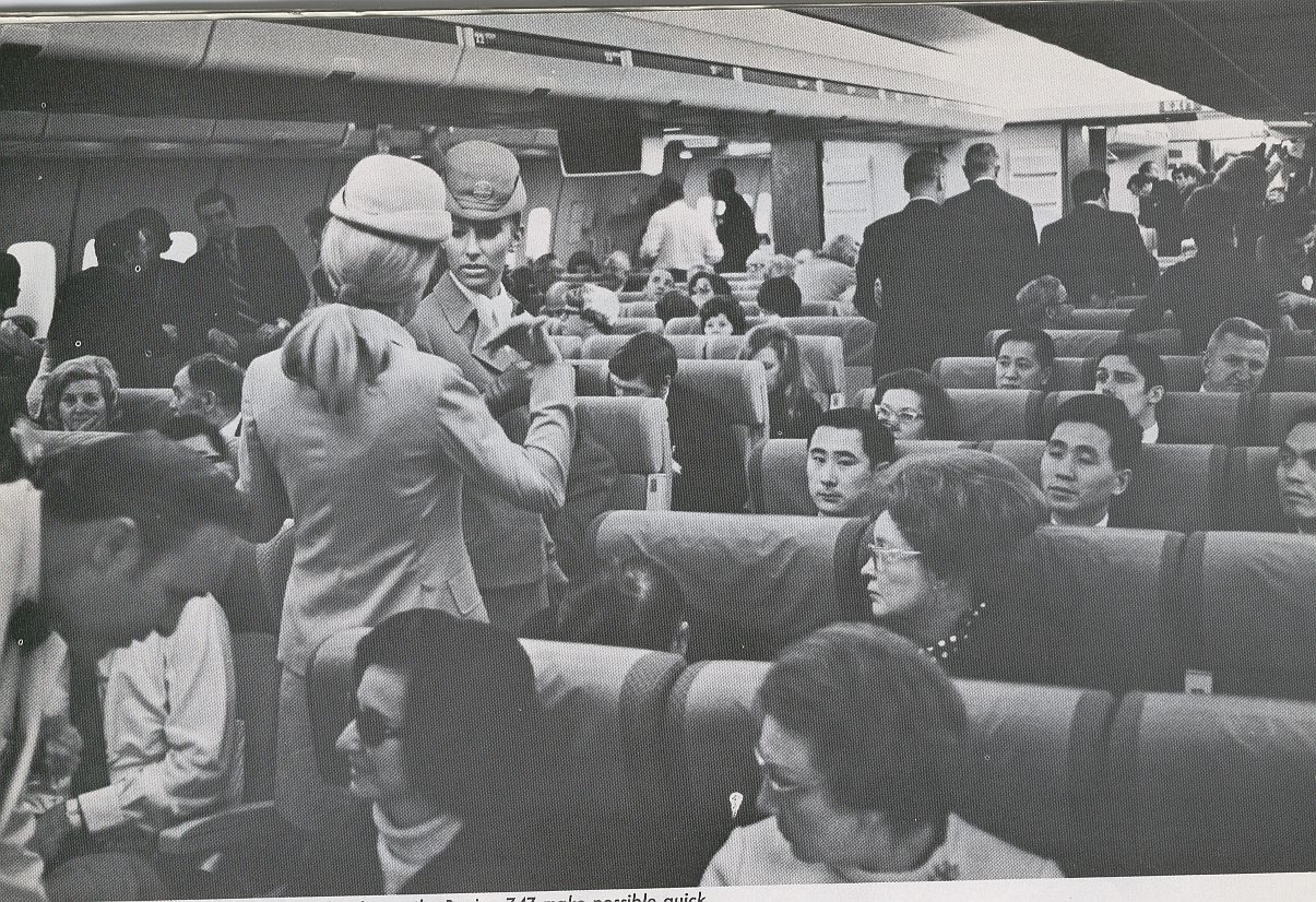 1970 Two Pan Am Flight Attendants  in the aisle of a 747.